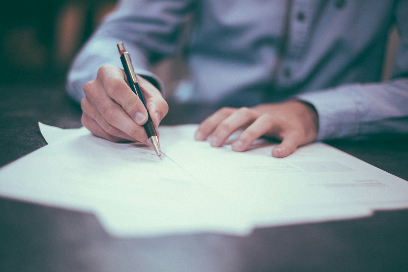 Papers and a pen on a desk