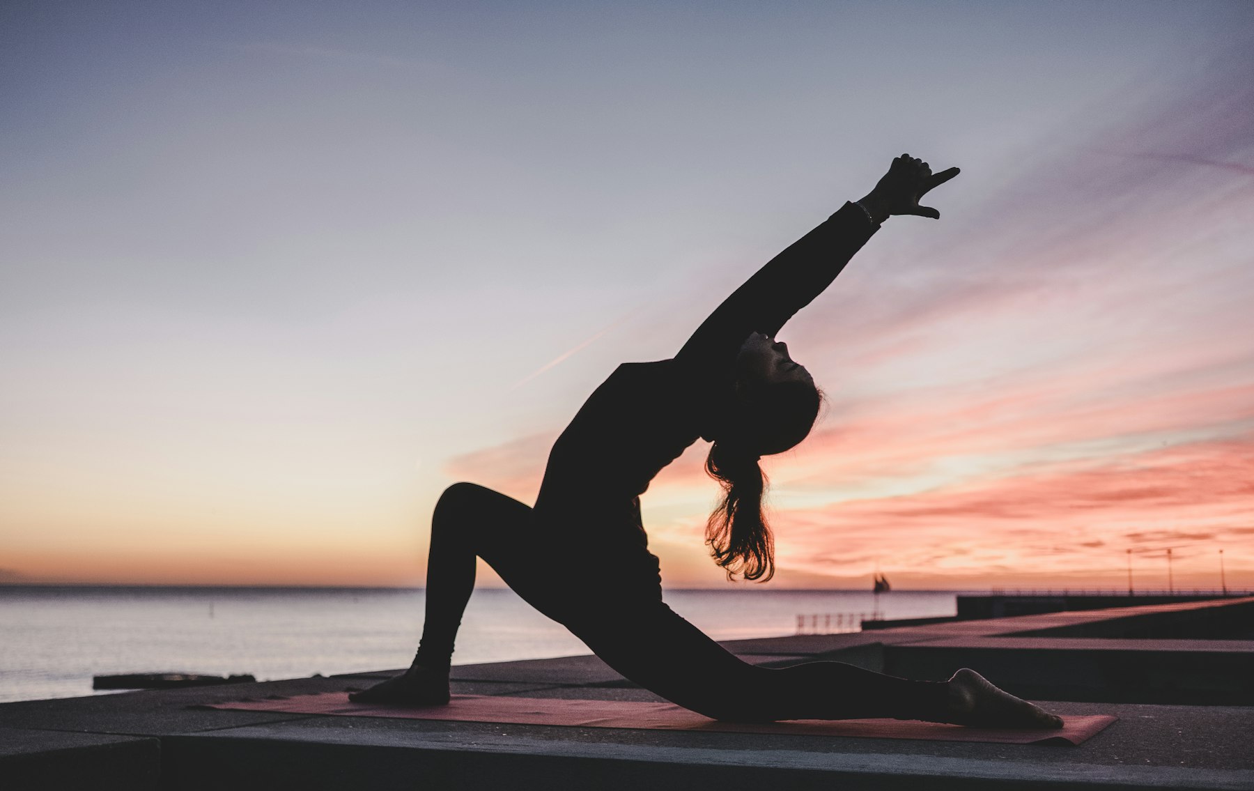 Yoga by the water at dusk